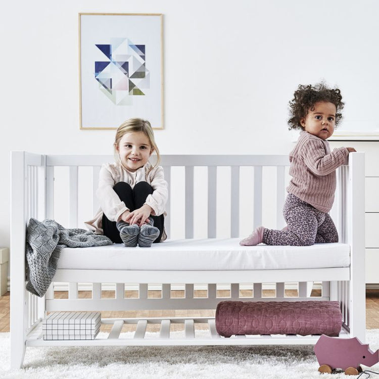 Cot bed with 2 toddlers on it