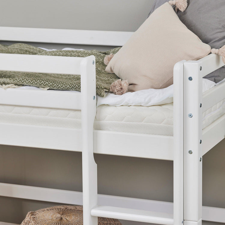 bunk bed with mattress and bedding on top