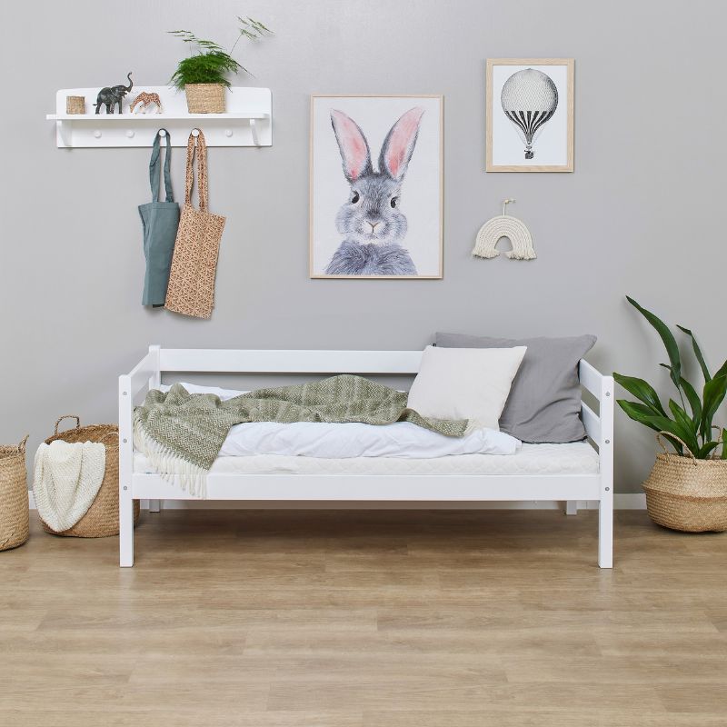 white wooden frame junior bed in  decorated room, front view