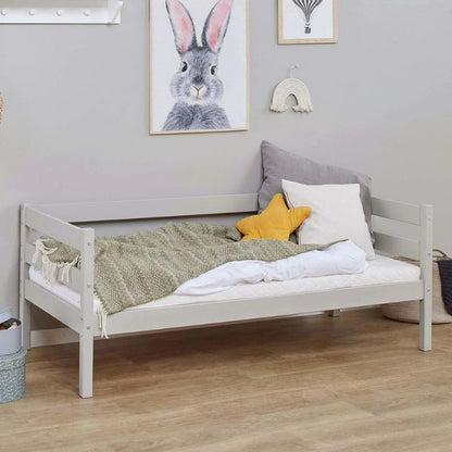 dove grey wooden frame junior bed in  decorated room, angled view