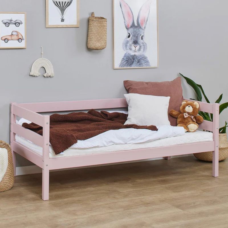 pale rose wooden frame junior bed in  decorated room, angled view