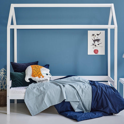 house bed in white with textiles in a blue room background