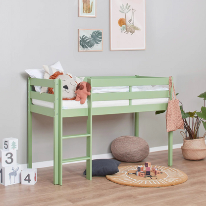 Green children's bed in a room with toys and decor