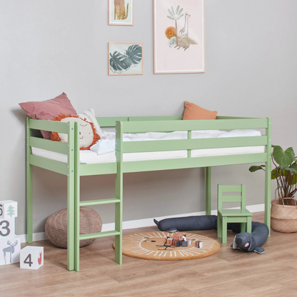 Green children's bed in a room with toys and decor