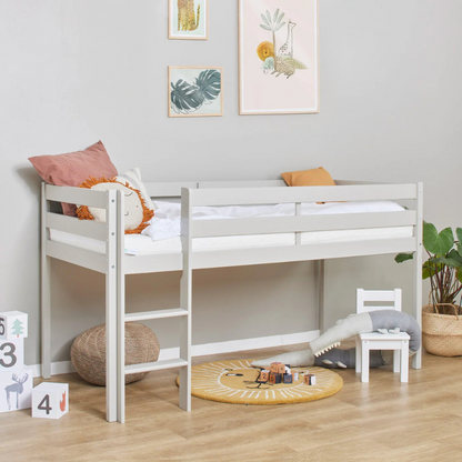 White children's bed in a room with toys and decor