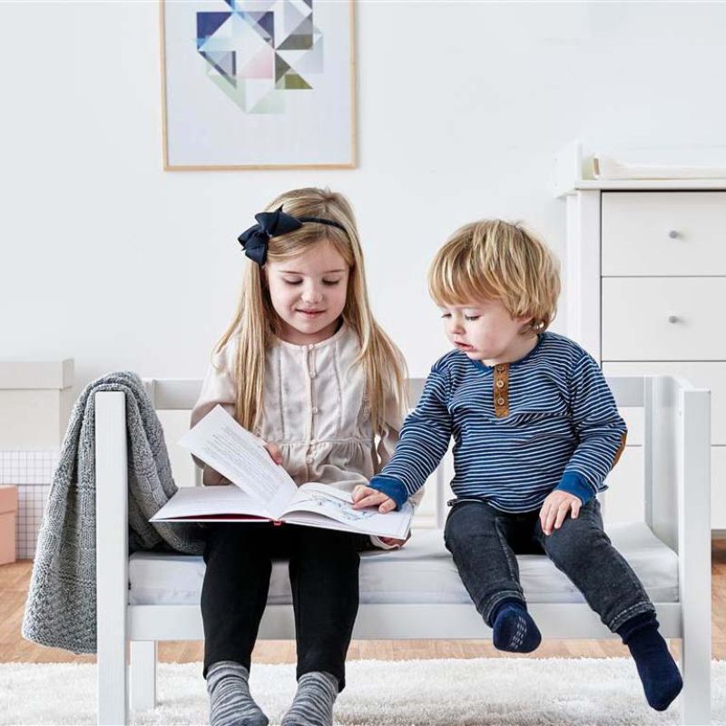 Tooders sitting on a cradle/bench