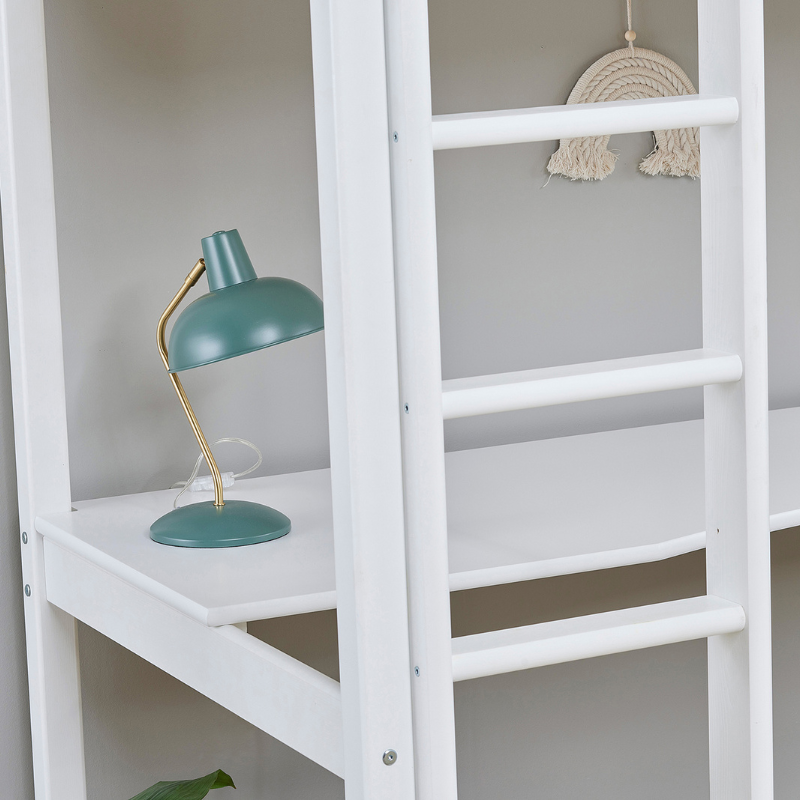 Close up of white desk fixed to white loft bed with teal lamp on a white background