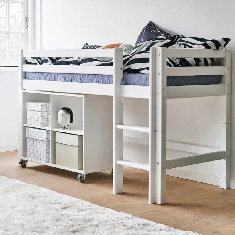 White loft bed with storage shelves in a room with wooden floor and white walls.