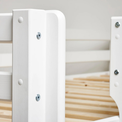 Close-up of a white wooden bed frame with slats.