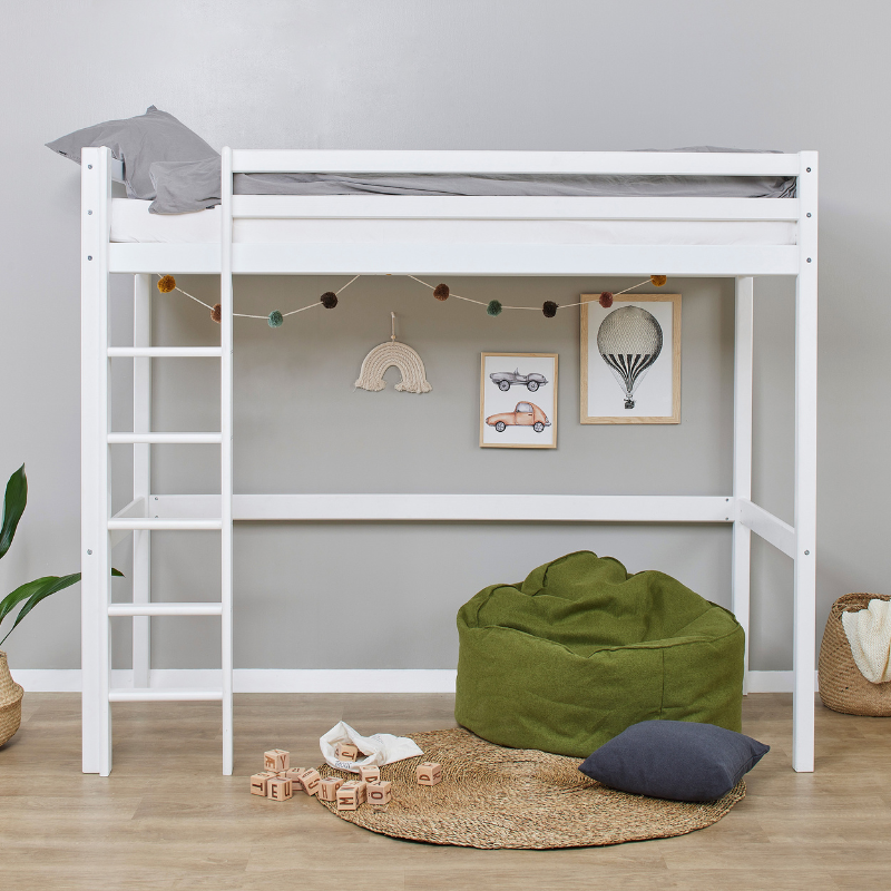 White loft bed with green bean bag and decorative items in a room.