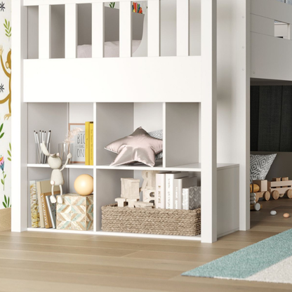 Close up of white mid sleeper bed  bookshelf and storage compartments in a room setting.